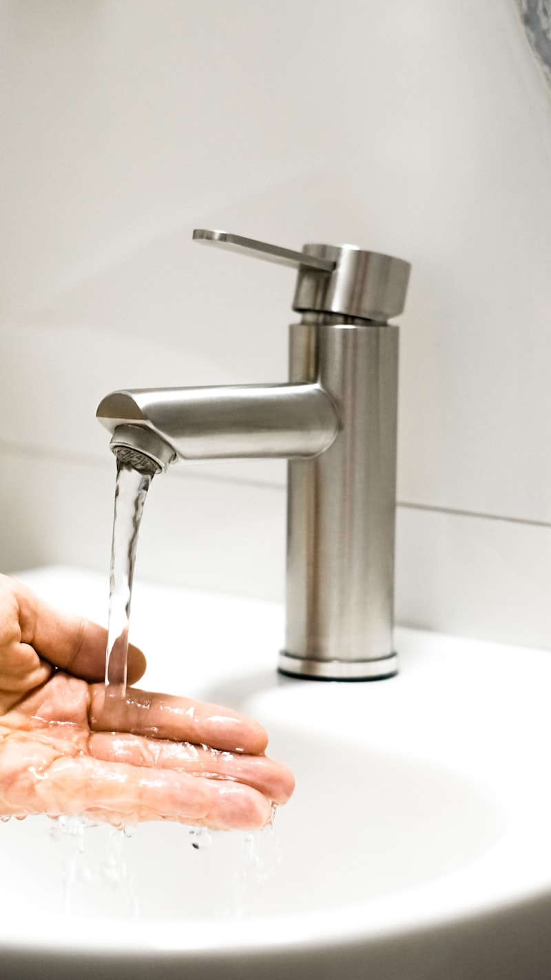 Plumber repairing a leaking faucet